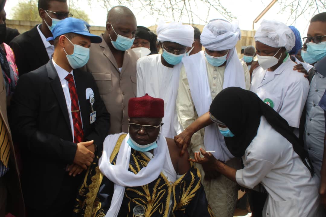 A traditional Chief getting vaccinated in the presence of the Minister of Health (third from right) at the launch of the vaccination campaign (Credit WHO/AFRO)